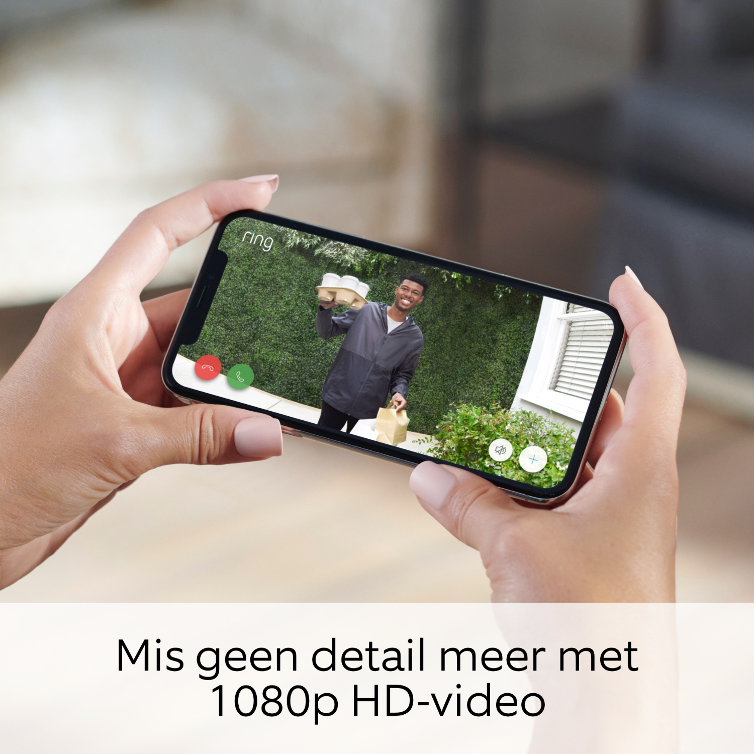 Hands holding a phone showing a video call with a person holding food.