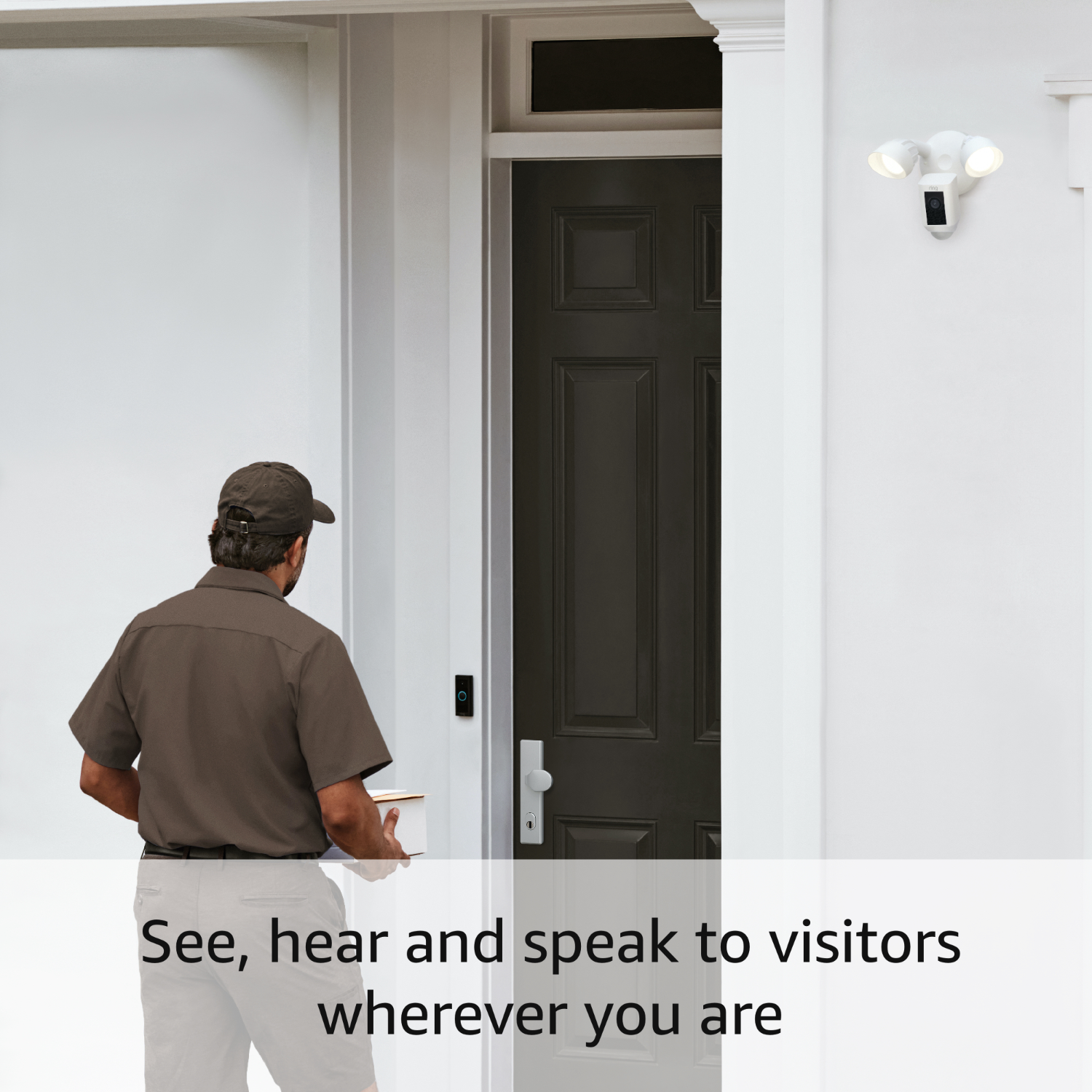 A delivery person near a door with a security system.