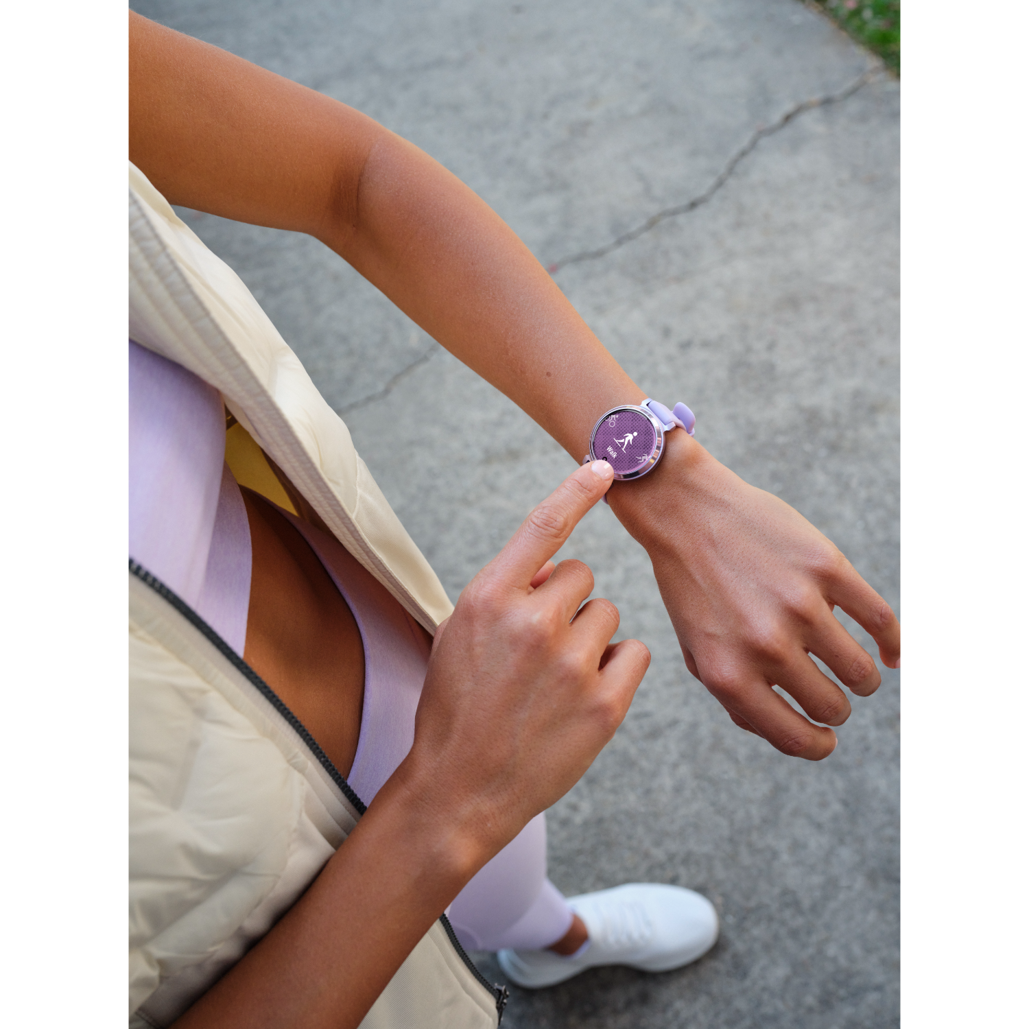 Woman's arm with a purple smartwatch, finger touching the screen.