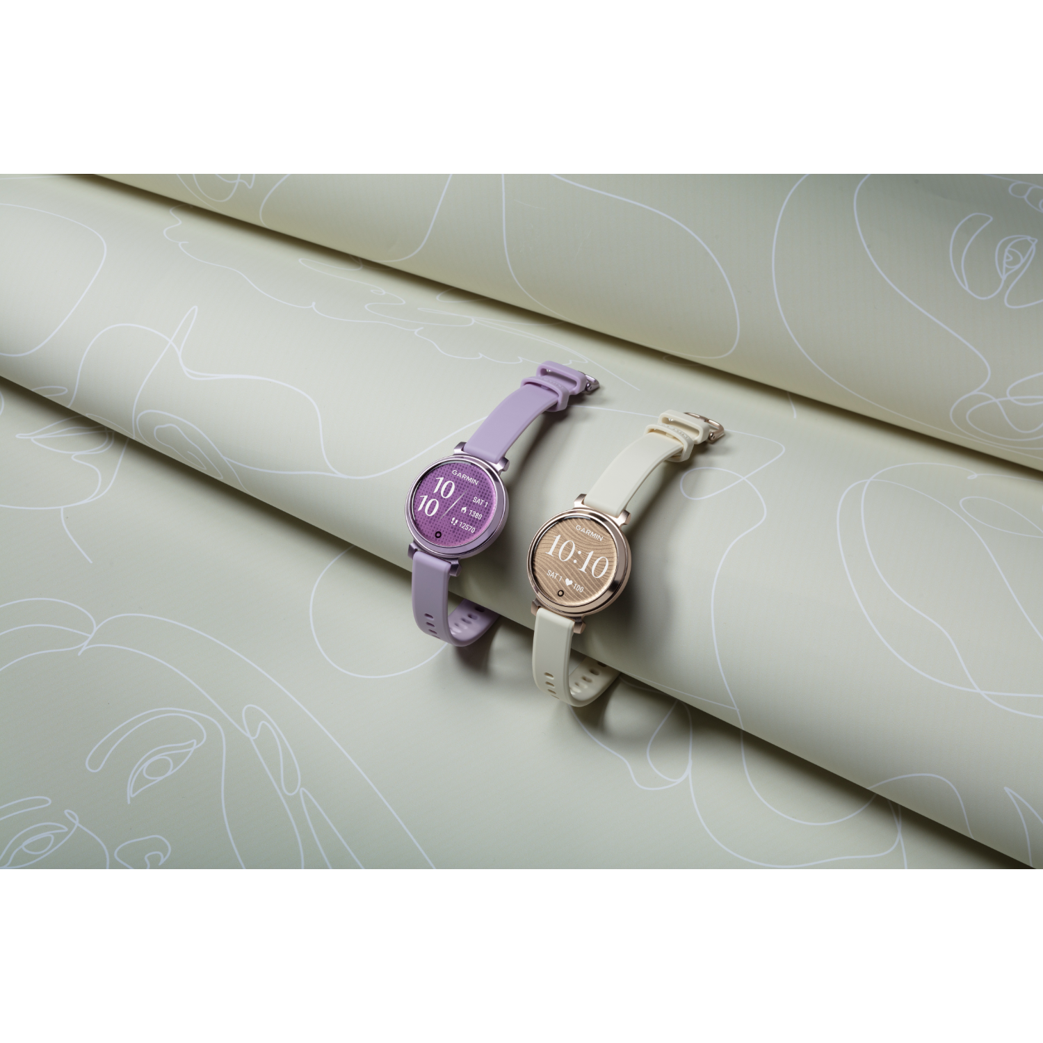 Two smartwatches with purple and white bands, displaying 10:10, on a patterned surface.
