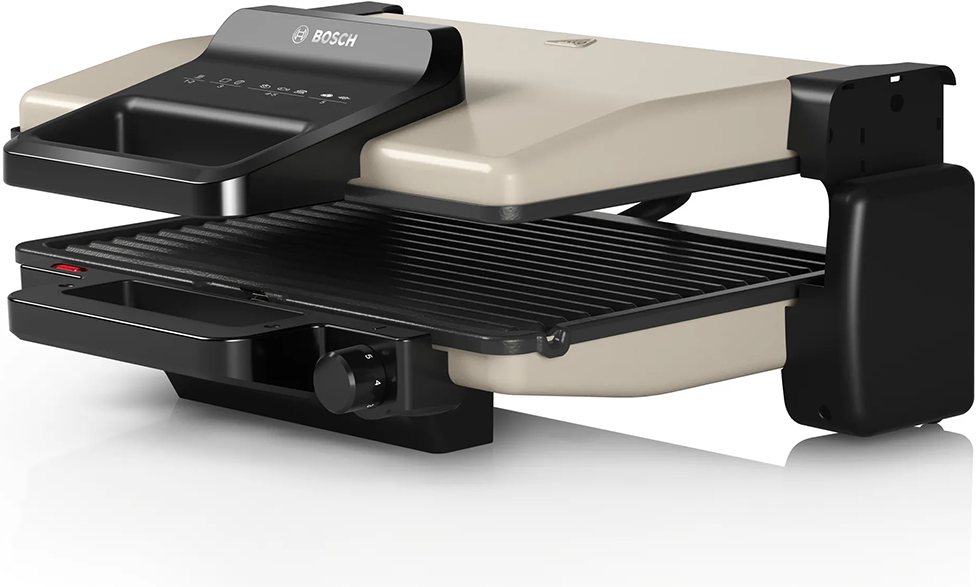 Egy bézs és fekete Bosch grill látható szögben, a grill nyitva van.