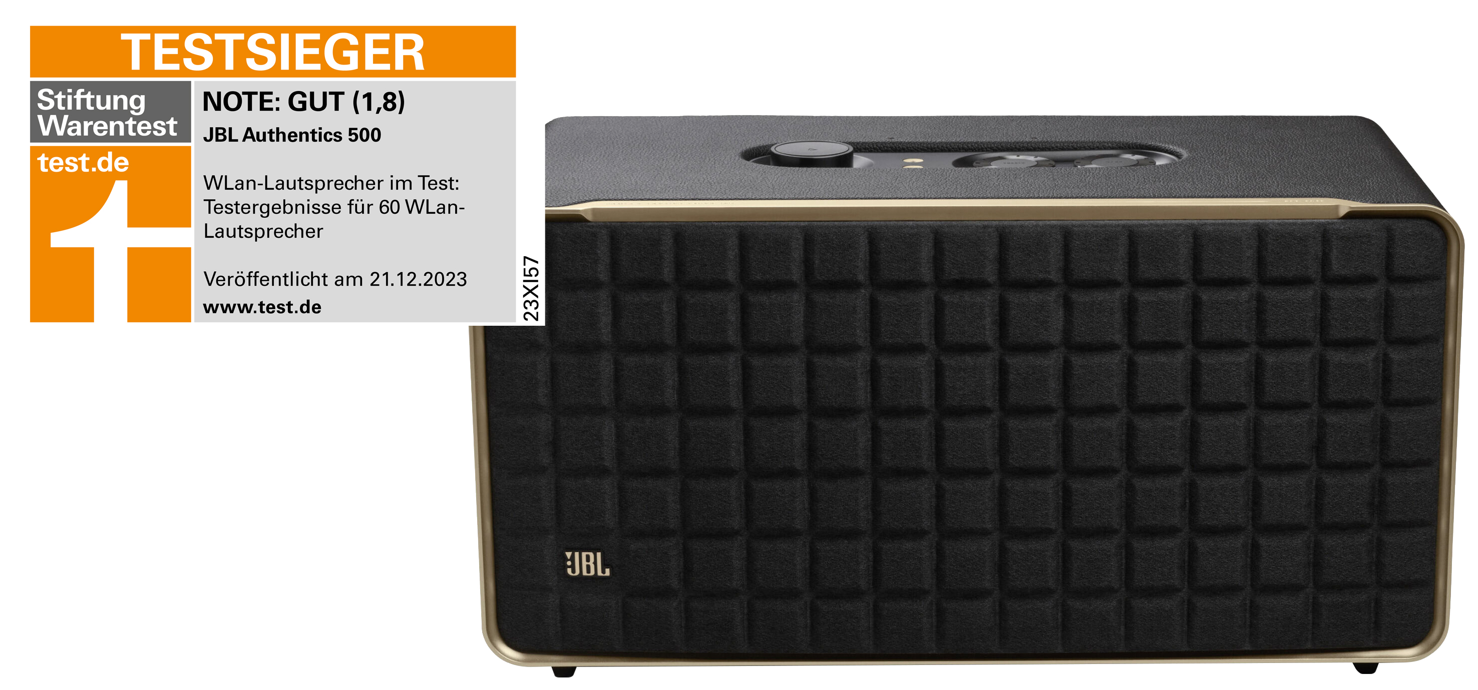 Haut-parleur noir et or avec une façade en tissu. Montre le logo Stiftung Warentest et la marque JBL.