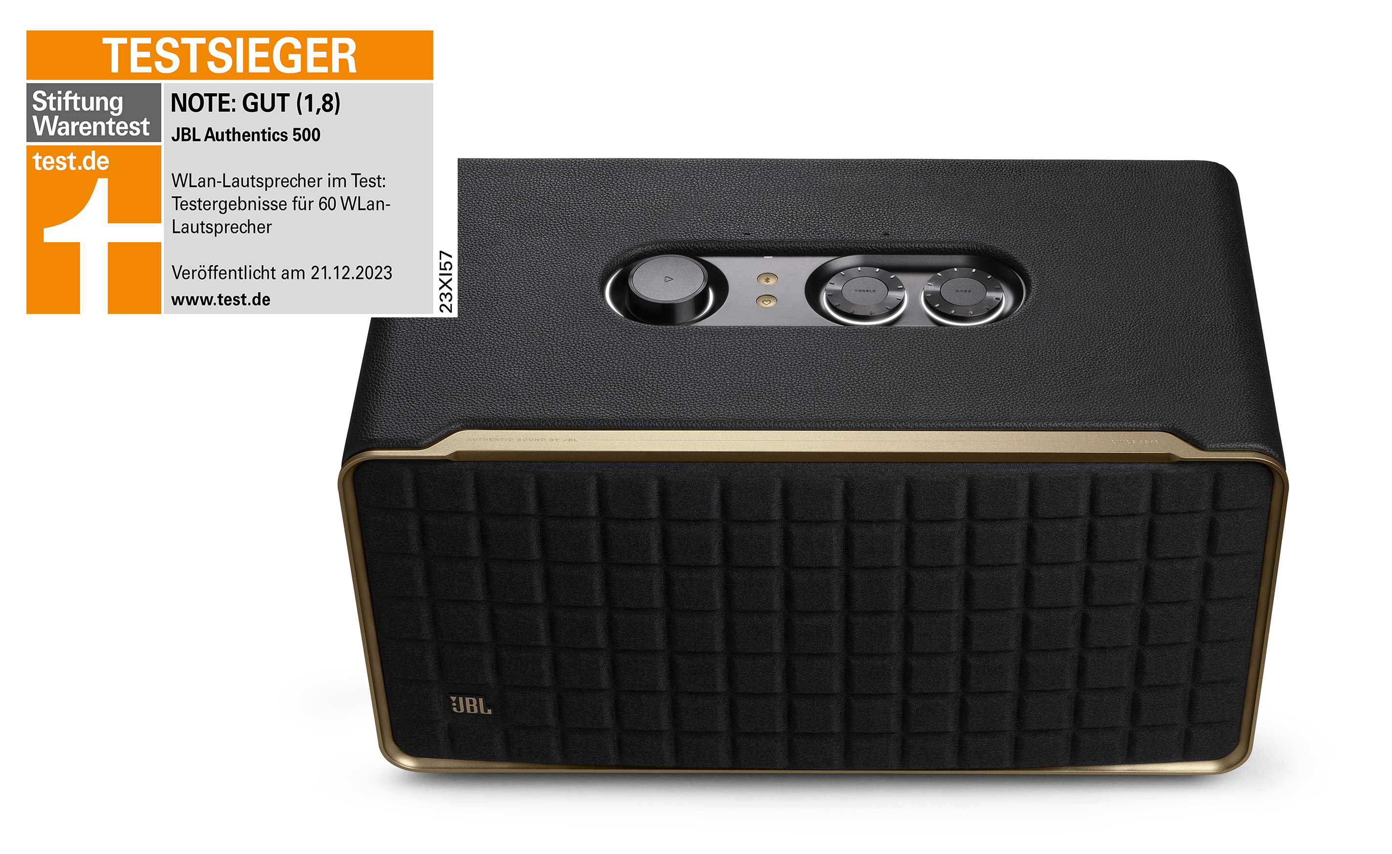 Enceinte JBL noire et dorée. Le dessus comporte des boutons de contrôle. L'étiquette indique 'Test Sieger' et 'JBL Authentics 500'.