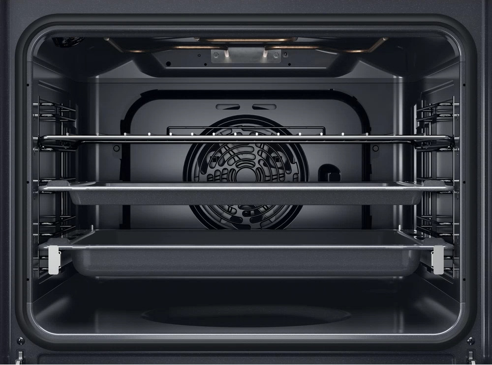 Oven interior with racks and a fan.