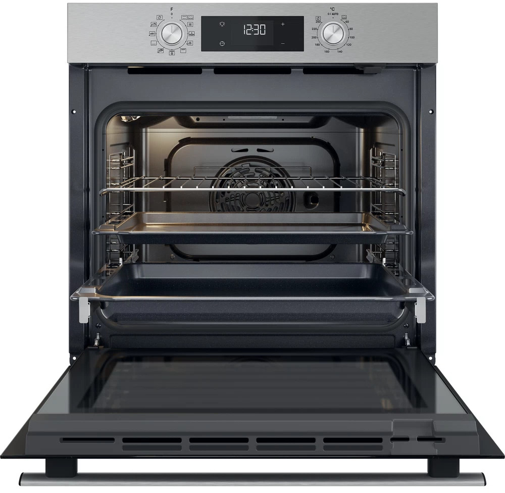 Open stainless steel oven with interior racks and trays, displaying the inside.