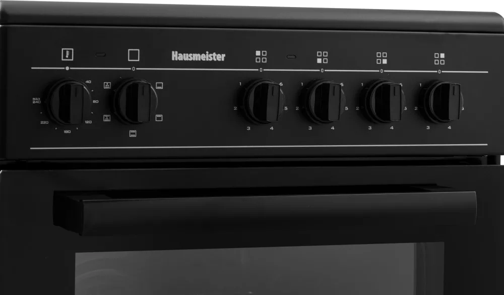 A fekete Hausmeister sütő vezérlőpaneljének közeli képe gombokkal és hőmérséklet jelölésekkel.