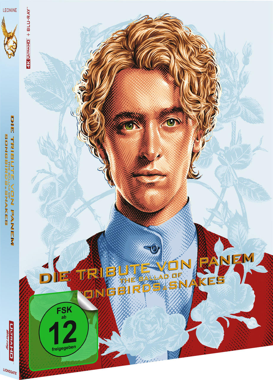 Das Cover des Films Die Tribute von Panem, ein Männergesicht, Text in Rot und Blau, ein grüner Aufkleber.