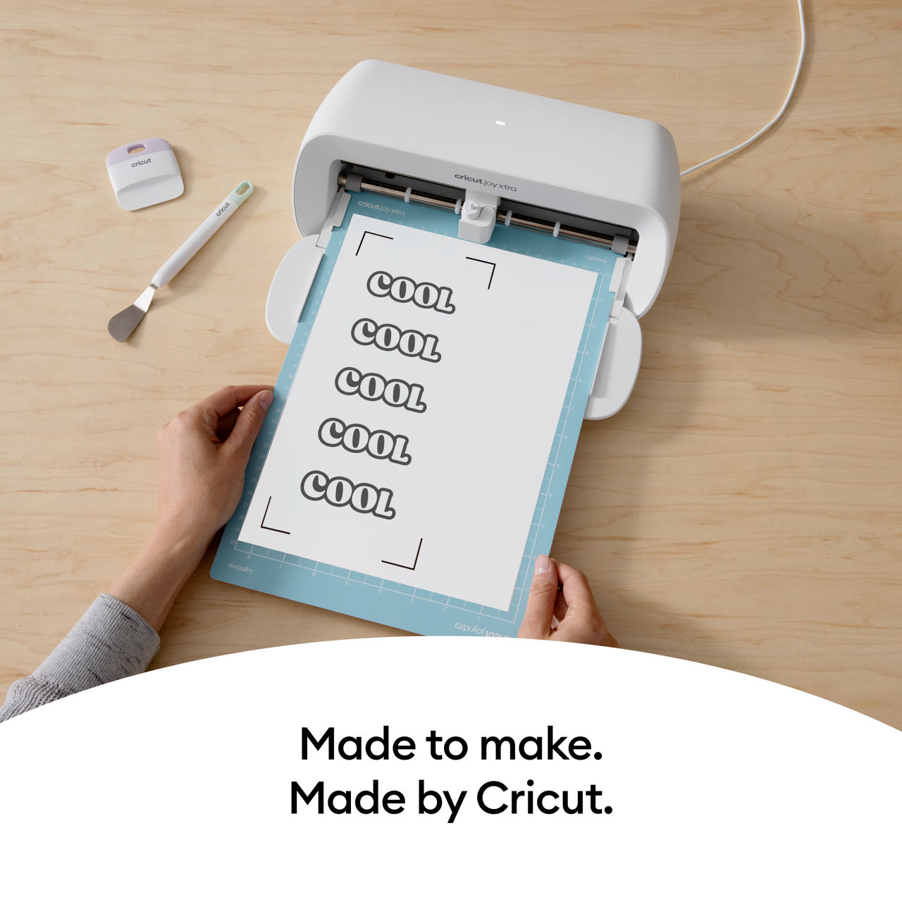 Cricut Joy Xtra Maschine schneidet Papier mit wiederholtem 'COOL'.