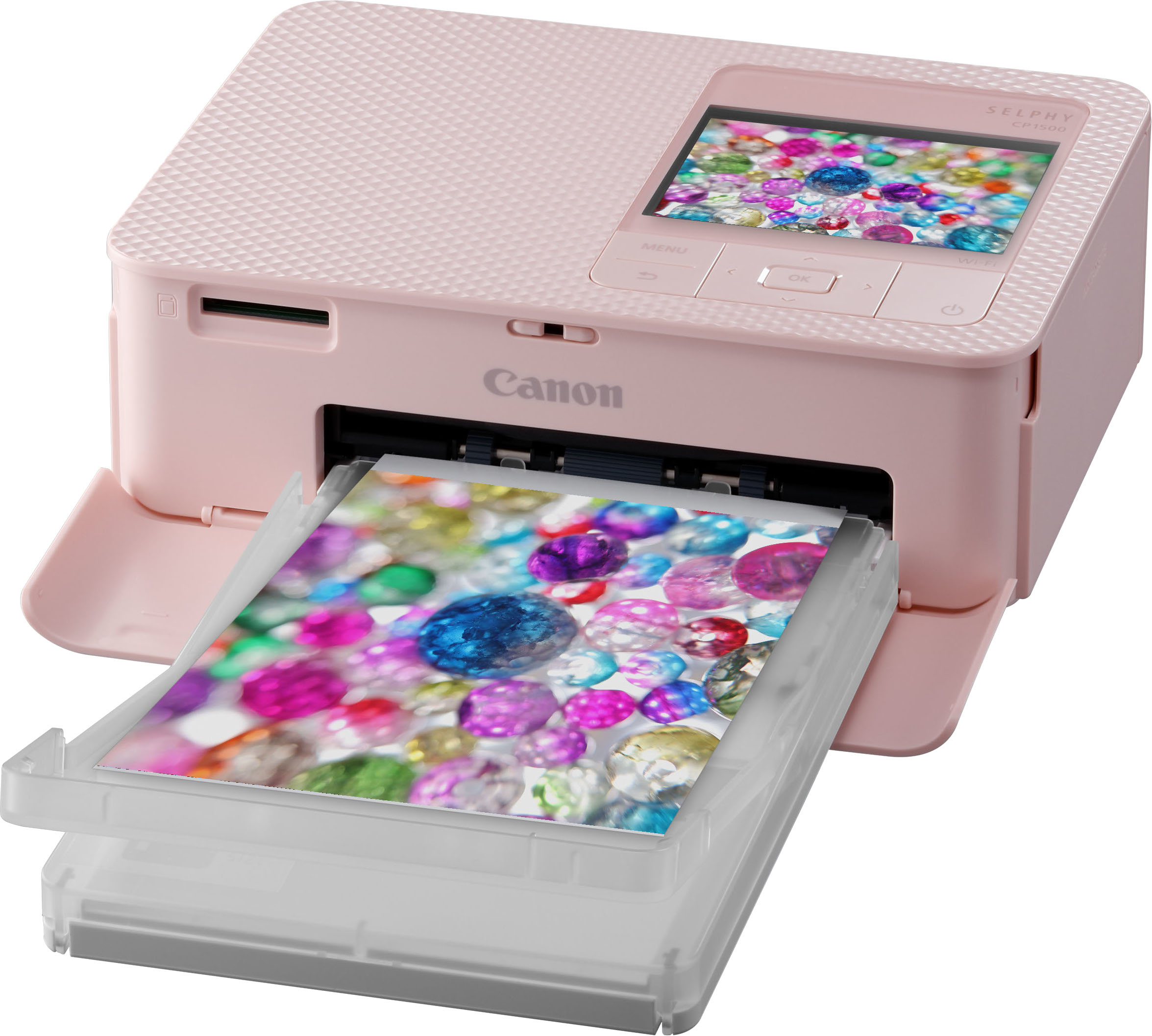 Pink Canon Selphy photo printer printing a colorful photo, with a tray of gems.