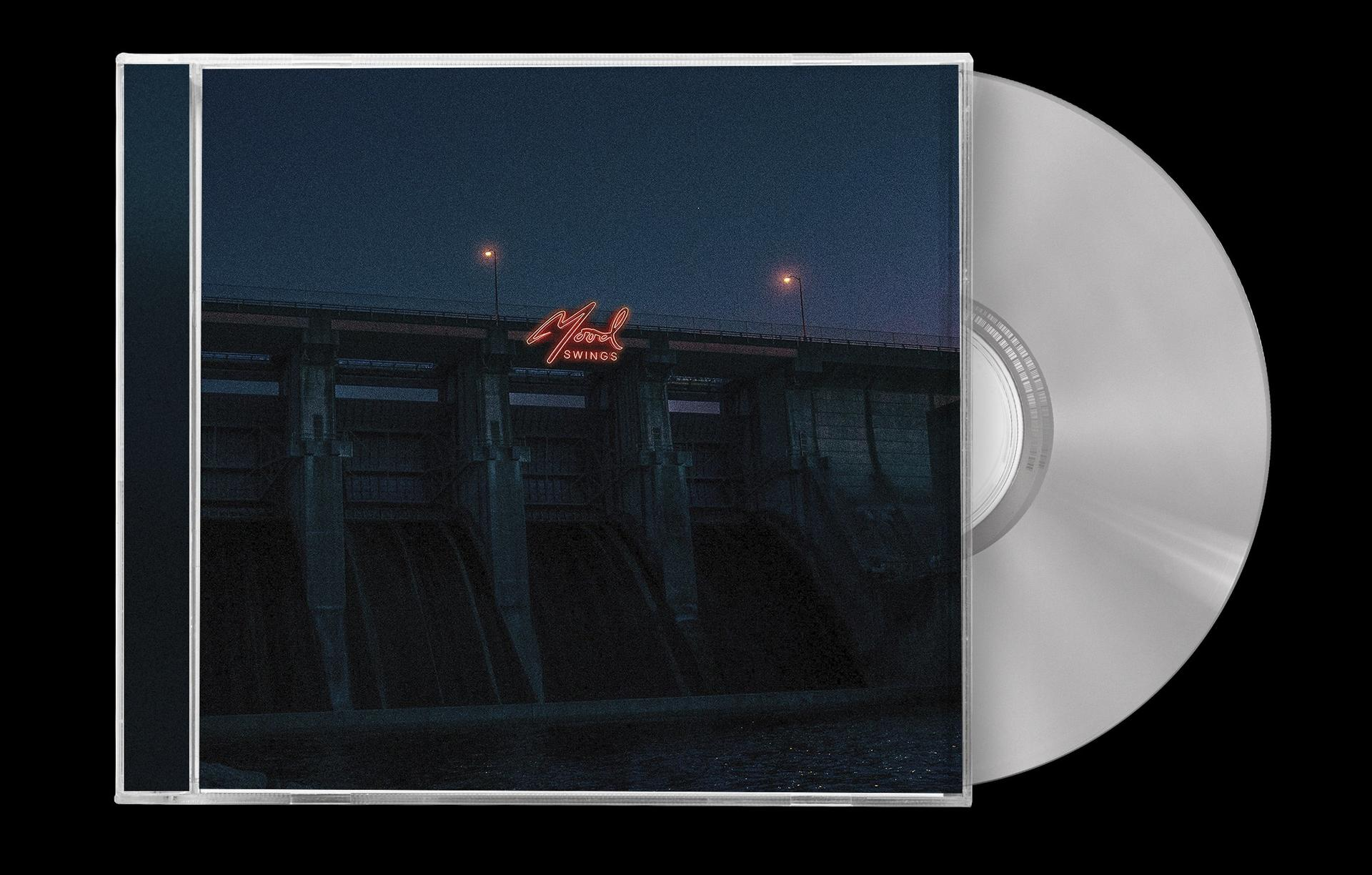 CD-Hülle mit dunkler Landschaft, Staudamm und Neonzeichen mit 'Mood Swings'.