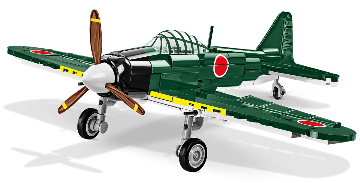 Ein grünes Modellflugzeug mit Propeller, rotem Kreis und weißen Details.
