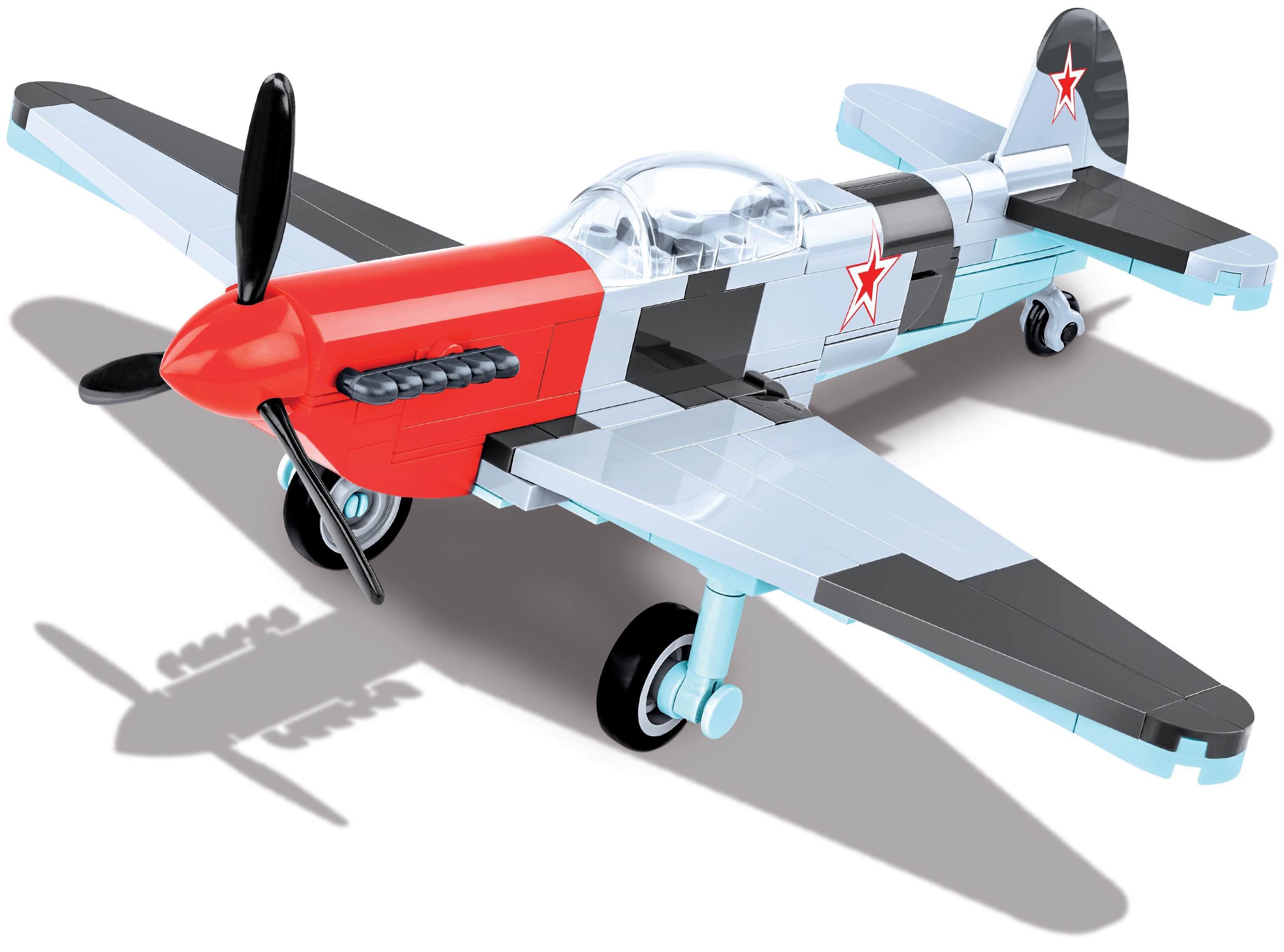 Ein hellblaues und rotes Spielzeugflugzeug mit schwarzem Propeller und rotem Stern auf dem Flügel.