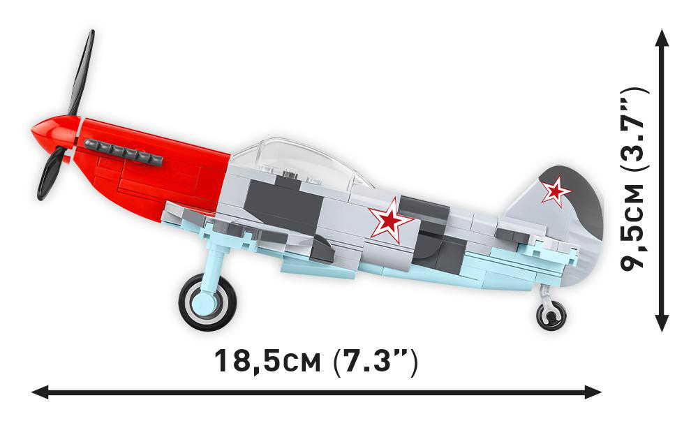 Ein Spielzeugflugzeug aus Blöcken, rot und grau mit einem Stern, und Maße in cm und Zoll.
