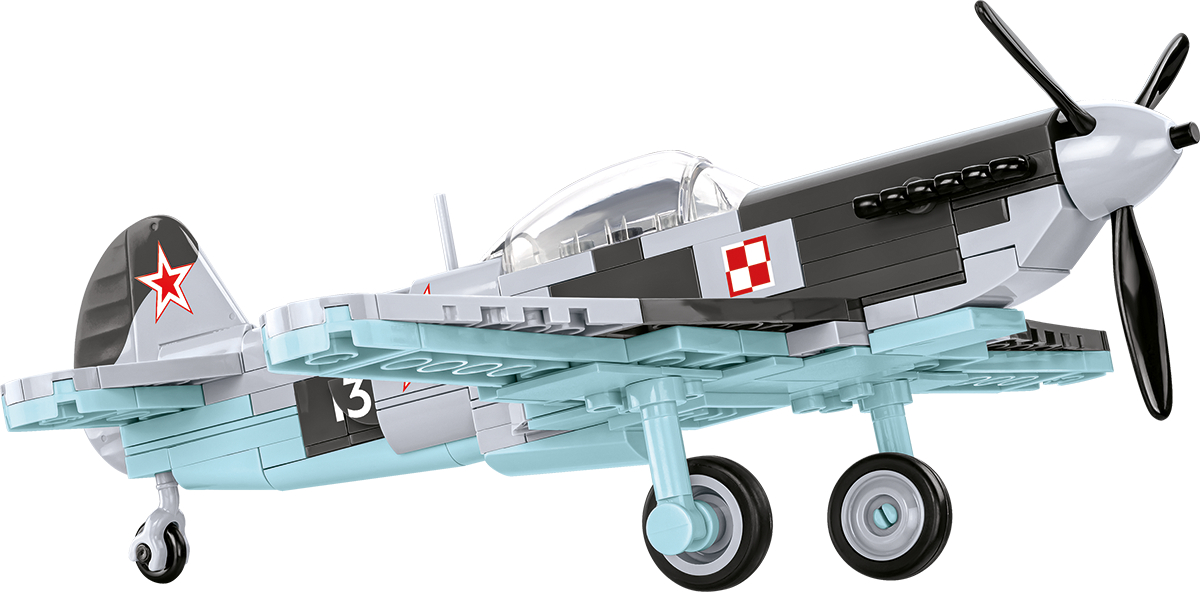 Ein Modellflugzeug aus Bausteinen, grau, blau und rot.
