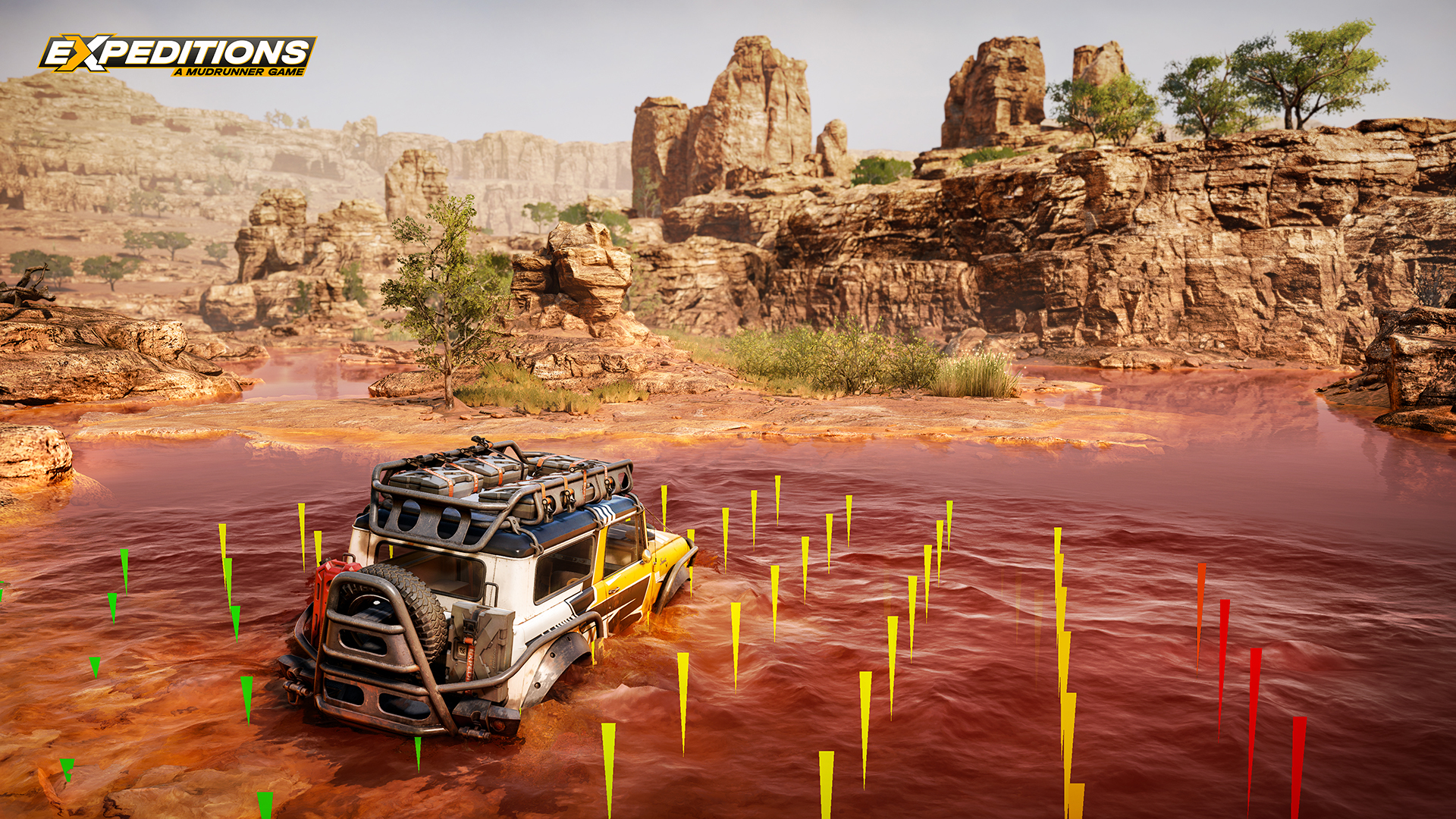 SUV blanc dans l'eau avec des poteaux jaunes ; rochers bruns et ciel en arrière-plan.