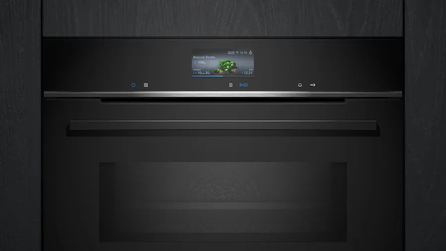 Czarny piekarnik z ekranem wyświetlającym instrukcje gotowania różyczek brokuła. Na ekranie widać czas i inne szczegóły.