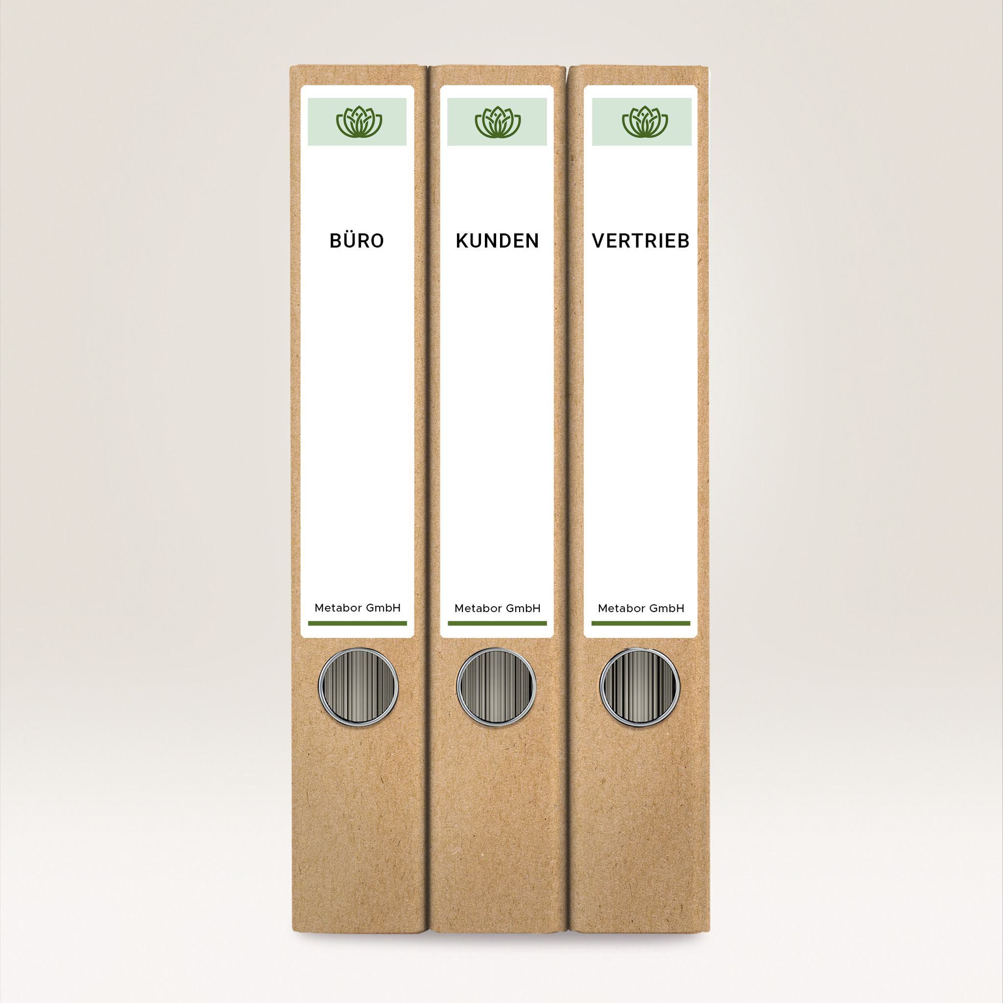 Drei braune Ordner mit den Aufschriften 'BÜRO', 'KUNDEN' und 'VERTRIEB'. Jeder hat ein grünes Logo und den Firmennamen 'Metabor GmbH'.