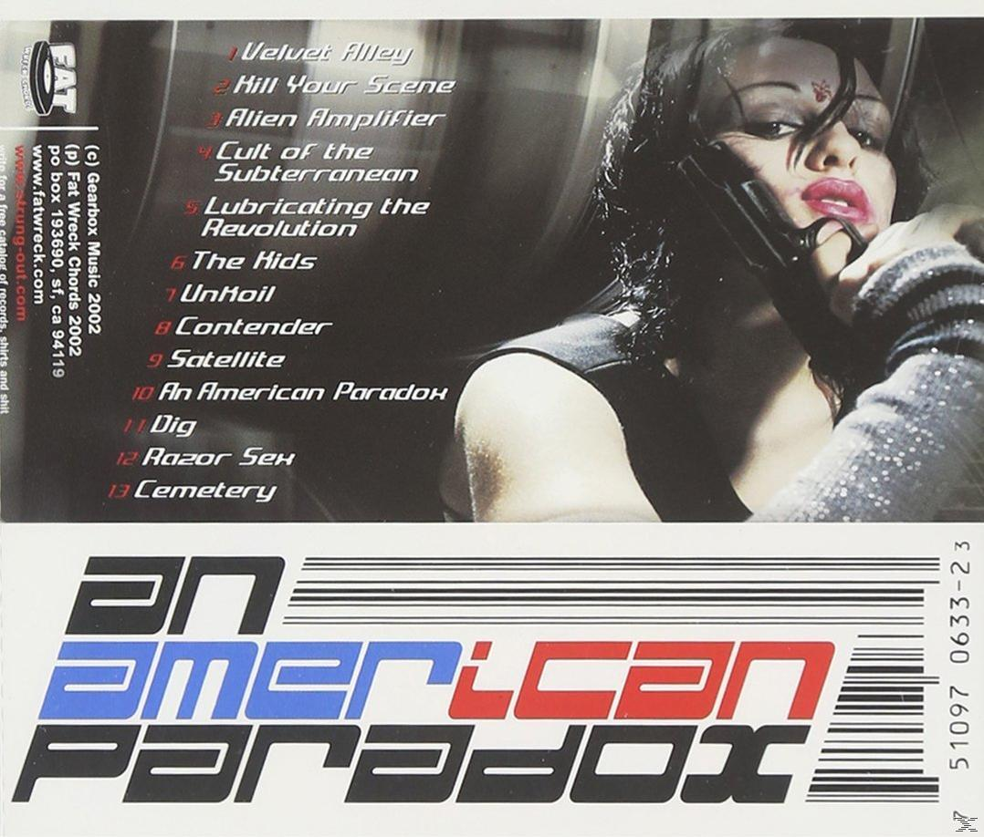 CD borító, kezében fegyverrel egy nő. Szöveg tartalmazza az 'An American Paradox' és a zenekar dalcímeit.