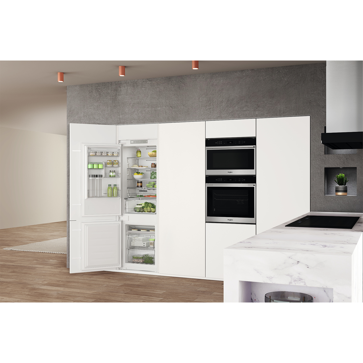 Una cucina moderna con mobili bianchi ed elettrodomestici integrati. Il frigorifero è aperto.