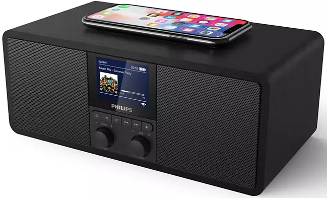 Haut-parleur noir avec un téléphone dessus et un écran affichant des informations musicales.