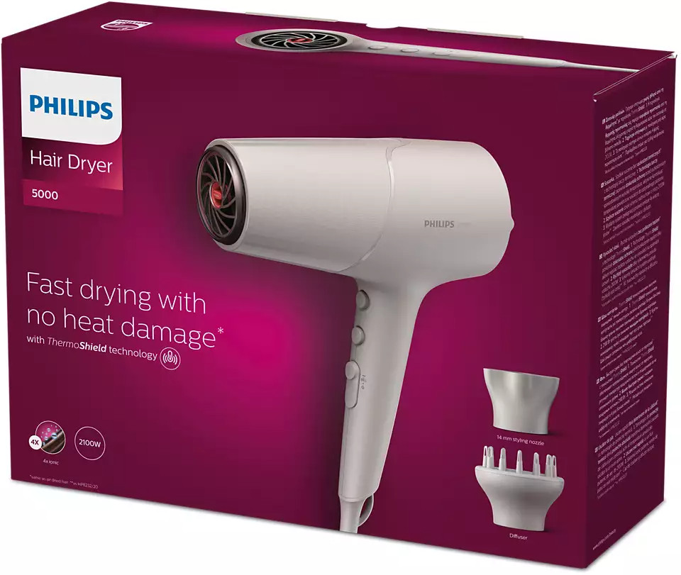 Witte Philips haardroger in een doos, met het apparaat en accessoires. De doos is voornamelijk rood.