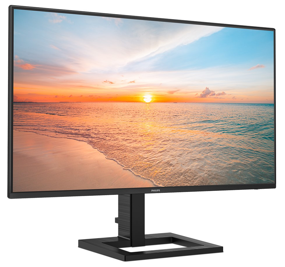 Ein Monitor zeigt eine Strandszene bei Sonnenuntergang. Ein schwarzer Monitorständer ist sichtbar.