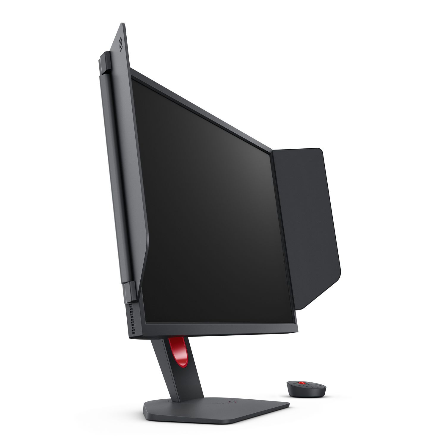 Un moniteur noir avec une visière latérale et un accent rouge sur le pied. Une petite télécommande est sur la surface blanche.