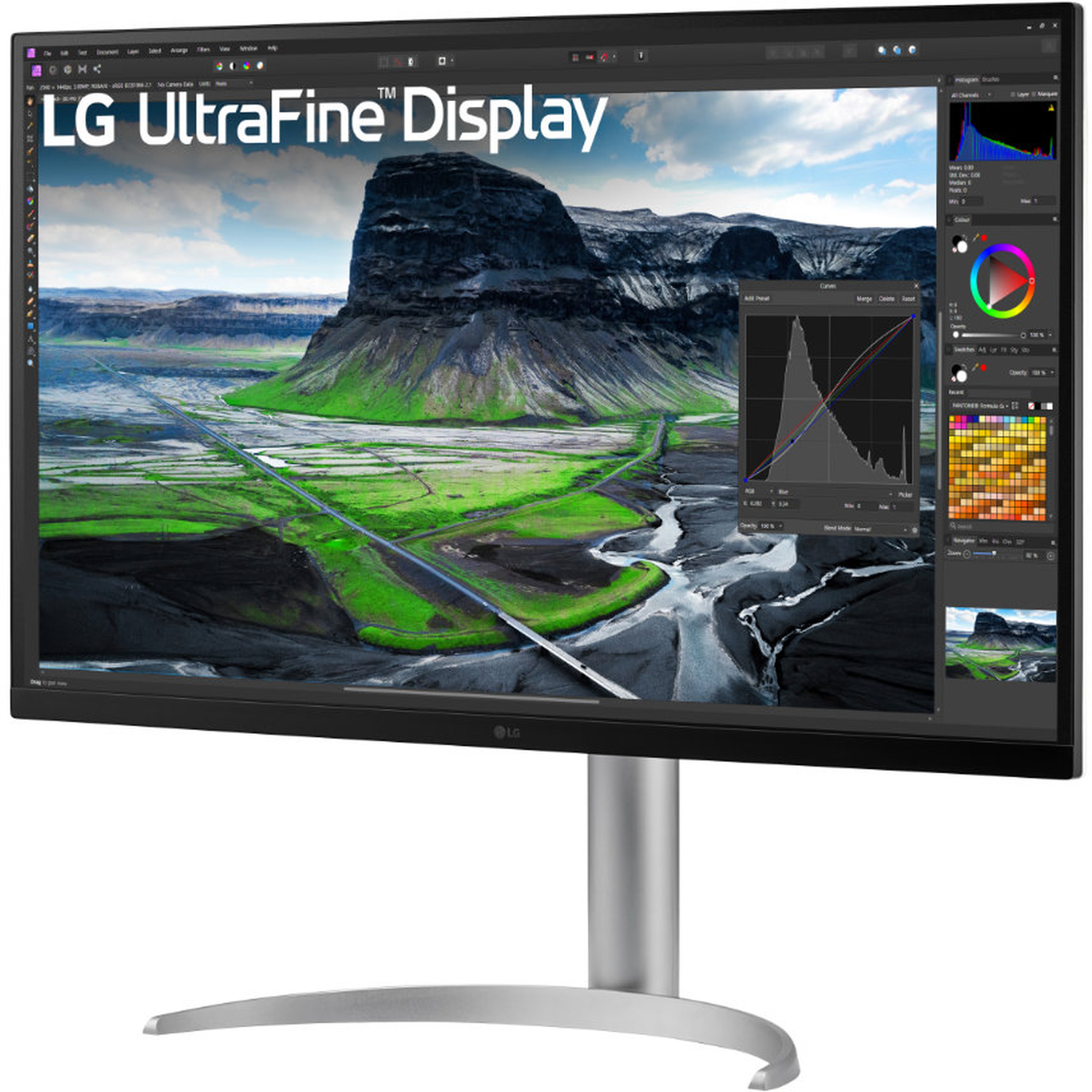 An LG UltraFine Display shows a landscape with mountains, green fields, and a cloudy sky. Software interface visible on display.