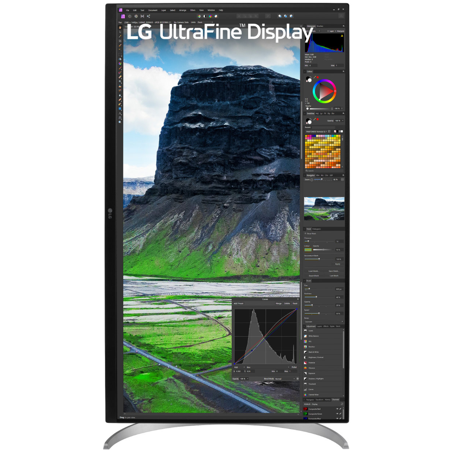 An LG UltraFine display shows a landscape image with mountain and editing software interface.