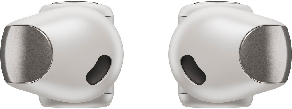 Close-up of white earbuds. Each has a metallic silver circle.  The left one has an L marking.