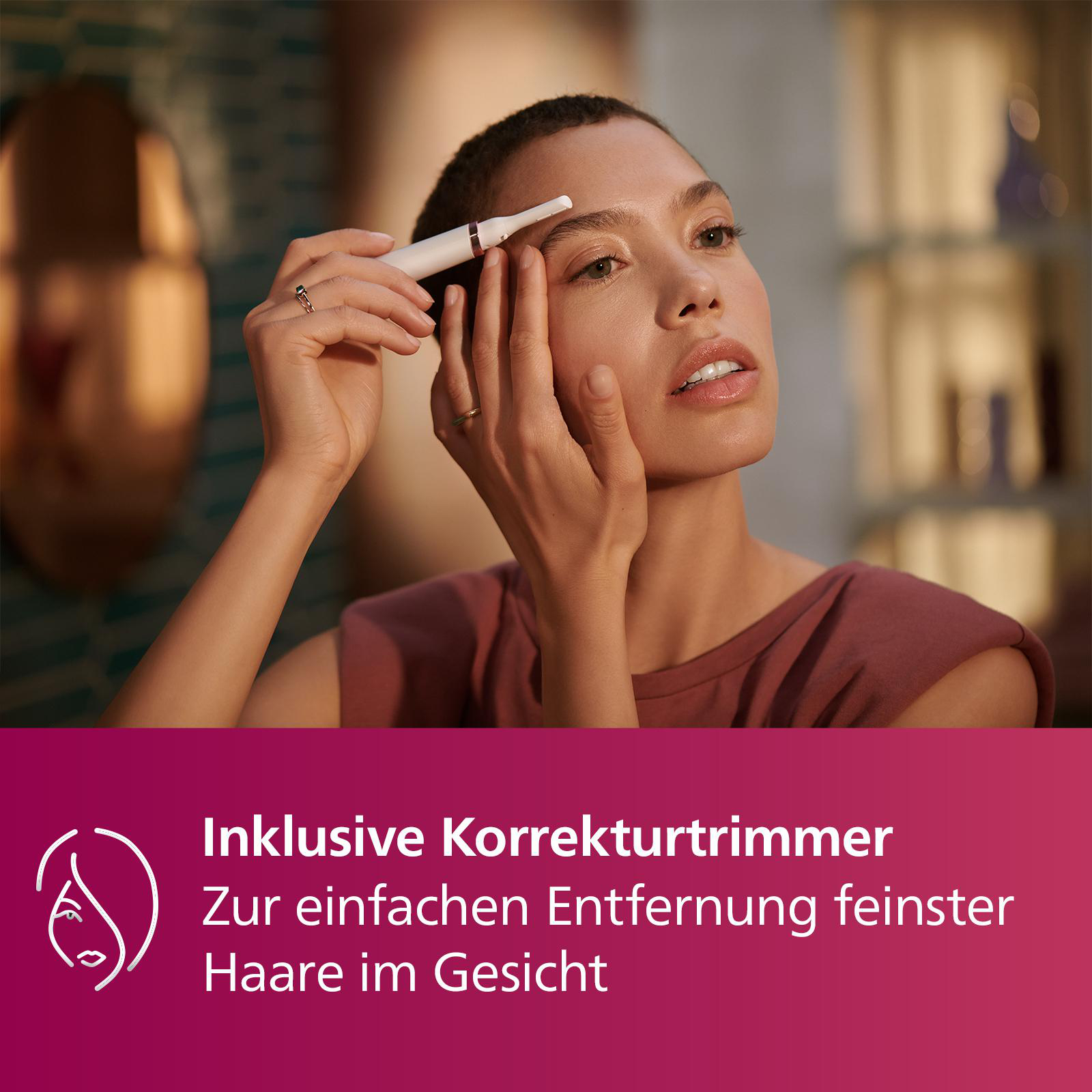 Frau trimmt Augenbrauen mit kleinem weißen Gerät, blickt in die Kamera.