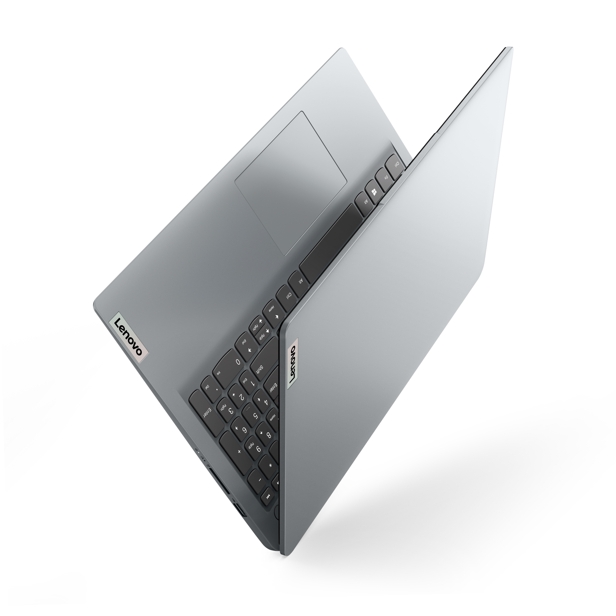 Un portátil Lenovo abierto sobre una superficie negra, mostrando el teclado.