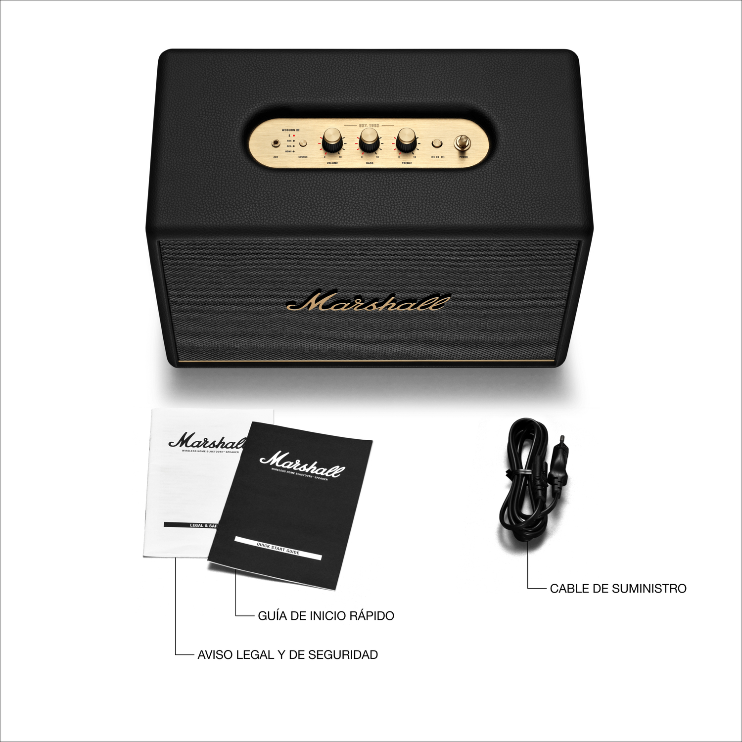 Altavoz Marshall negro con detalles dorados, manuales y cable de alimentación sobre fondo blanco.