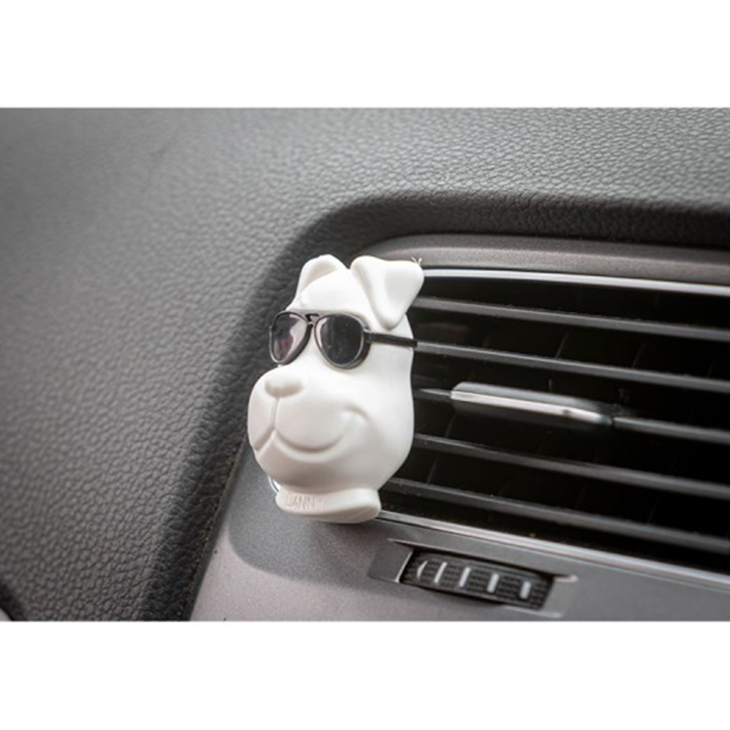 Profumatore per auto a forma di cane bianco con occhiali da sole, su una presa d'aria.