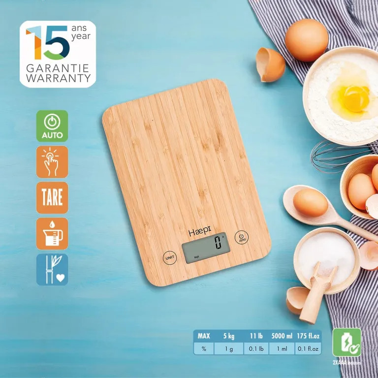 Wooden kitchen scale with digital display and various ingredients on a blue surface.