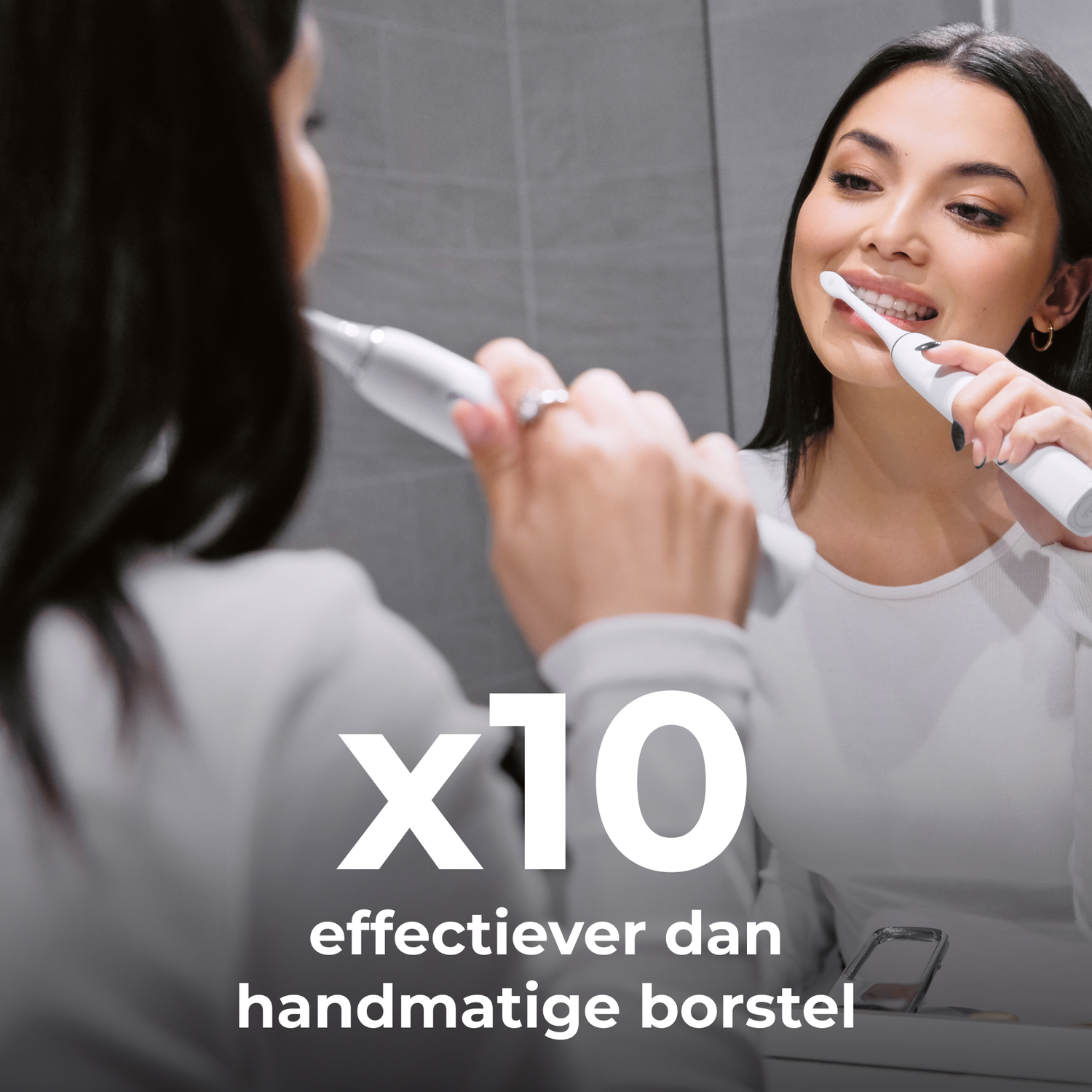 A woman brushing her teeth in front of a mirror. White toothbrush.