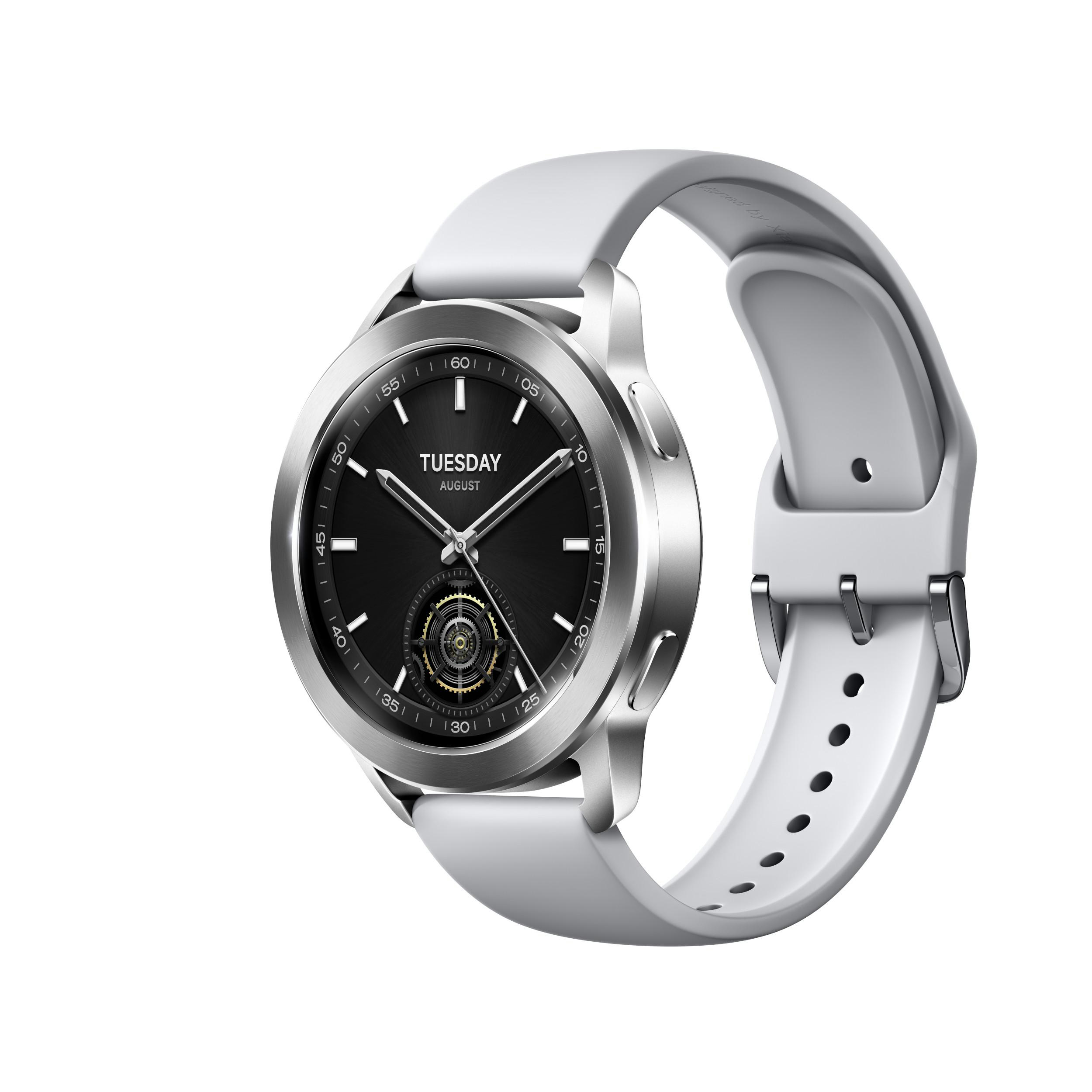 Silberne Smartwatch mit schwarzem Zifferblatt, weißem Armband und silbernen Details.