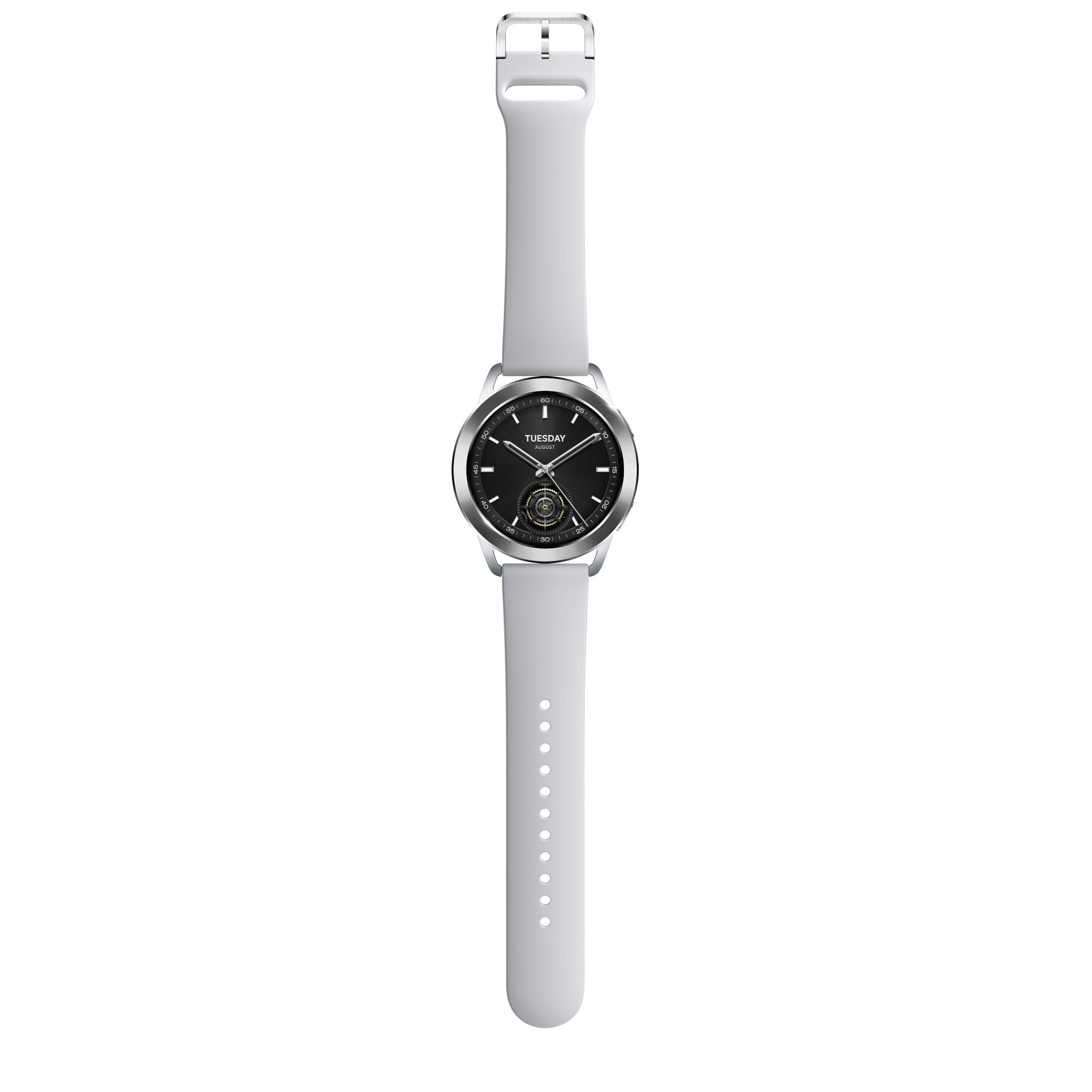 Eine weiße Smartwatch mit schwarzem Zifferblatt, silbernem Ziffernblatt und hellgrauem Armband, zentriert auf weißem Hintergrund.