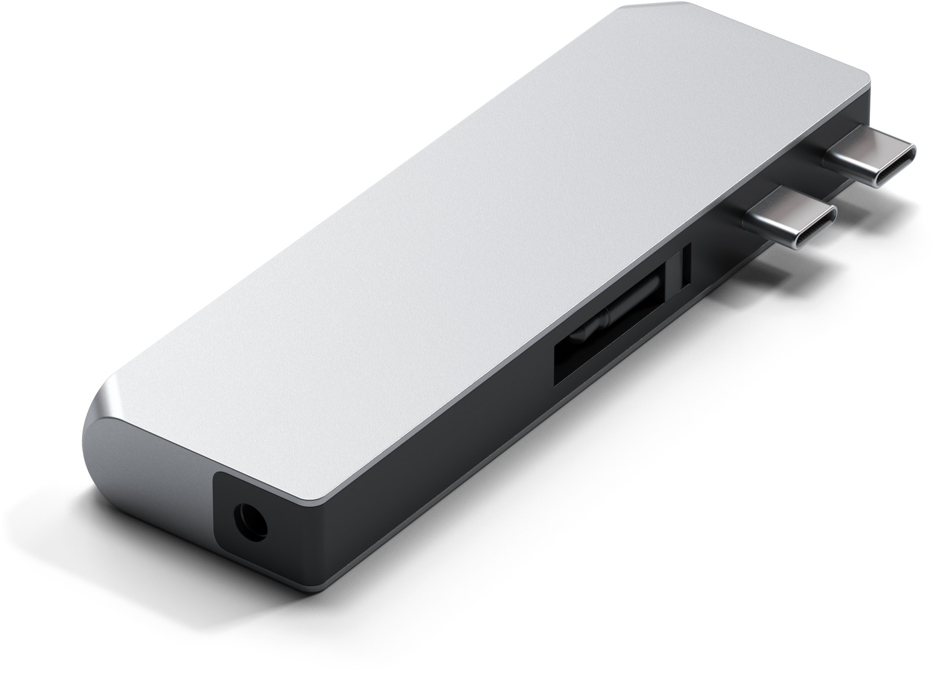 Egy ezüst színű USB-C hub több porttal. Lekerekített vége és fekete árnyéka van.