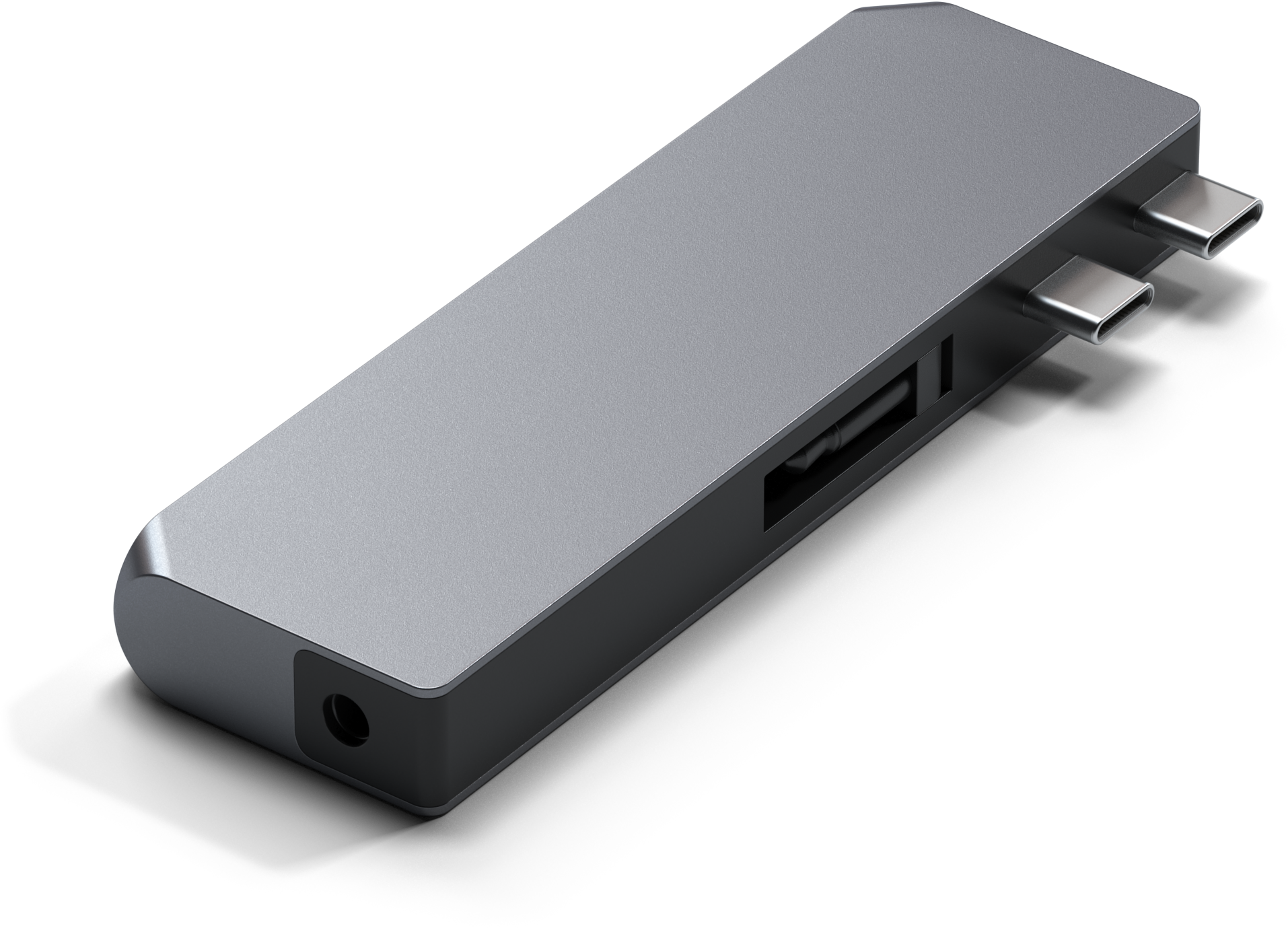 Egy szürke USB-C hub több porttal, fehér felületre helyezve.