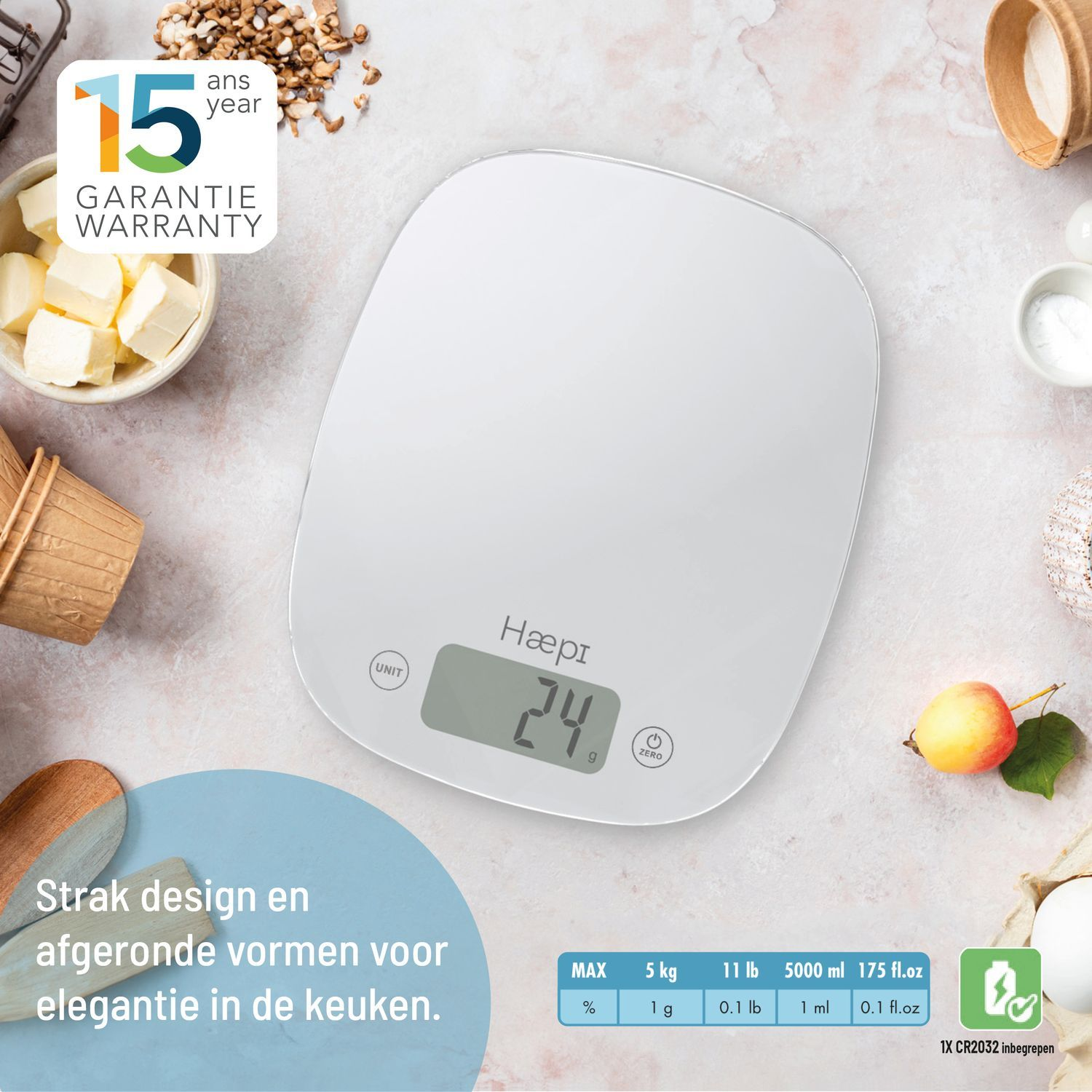 White kitchen scale with digital display, surrounded by ingredients and kitchen tools.