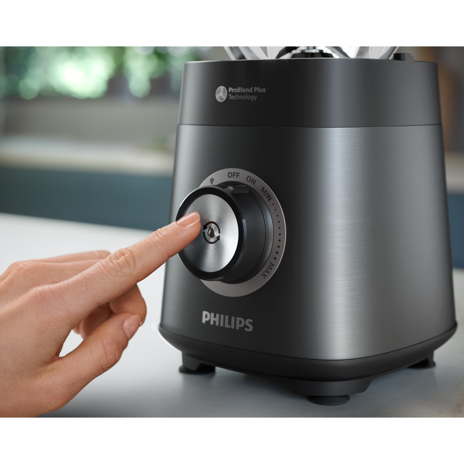 Hand pressing a button on a black Philips blender. The settings are visible.