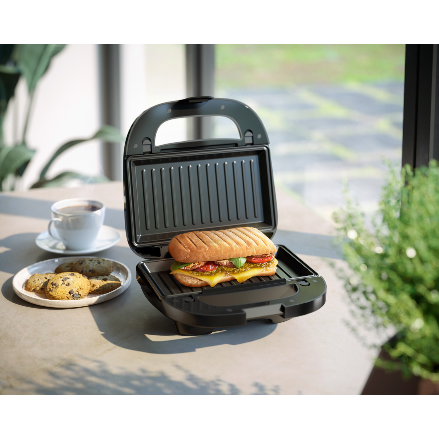 Sandwich maker with a sandwich inside, a cup of coffee, and cookies on a plate.