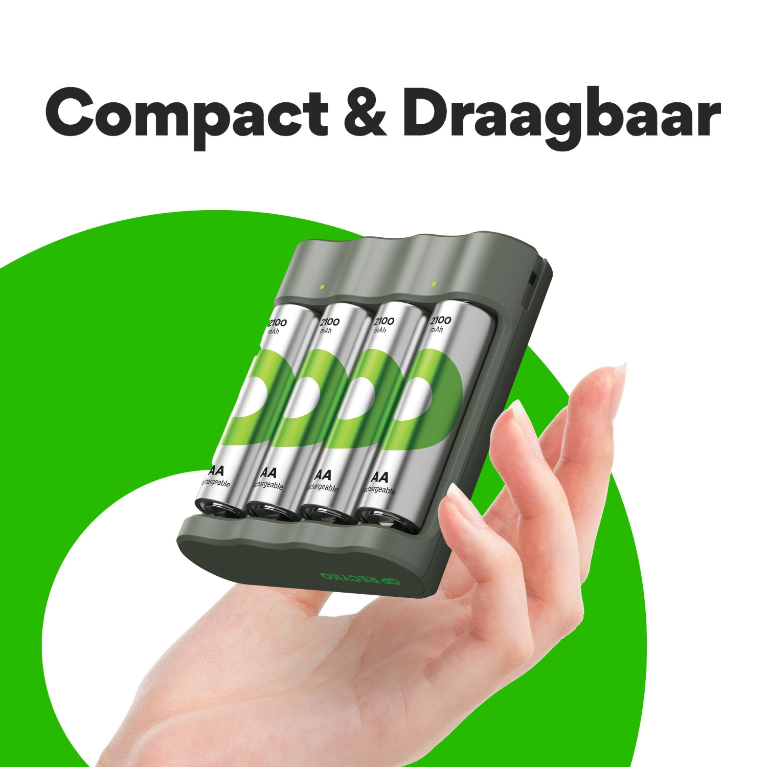 A hand holding a gray battery charger with batteries.