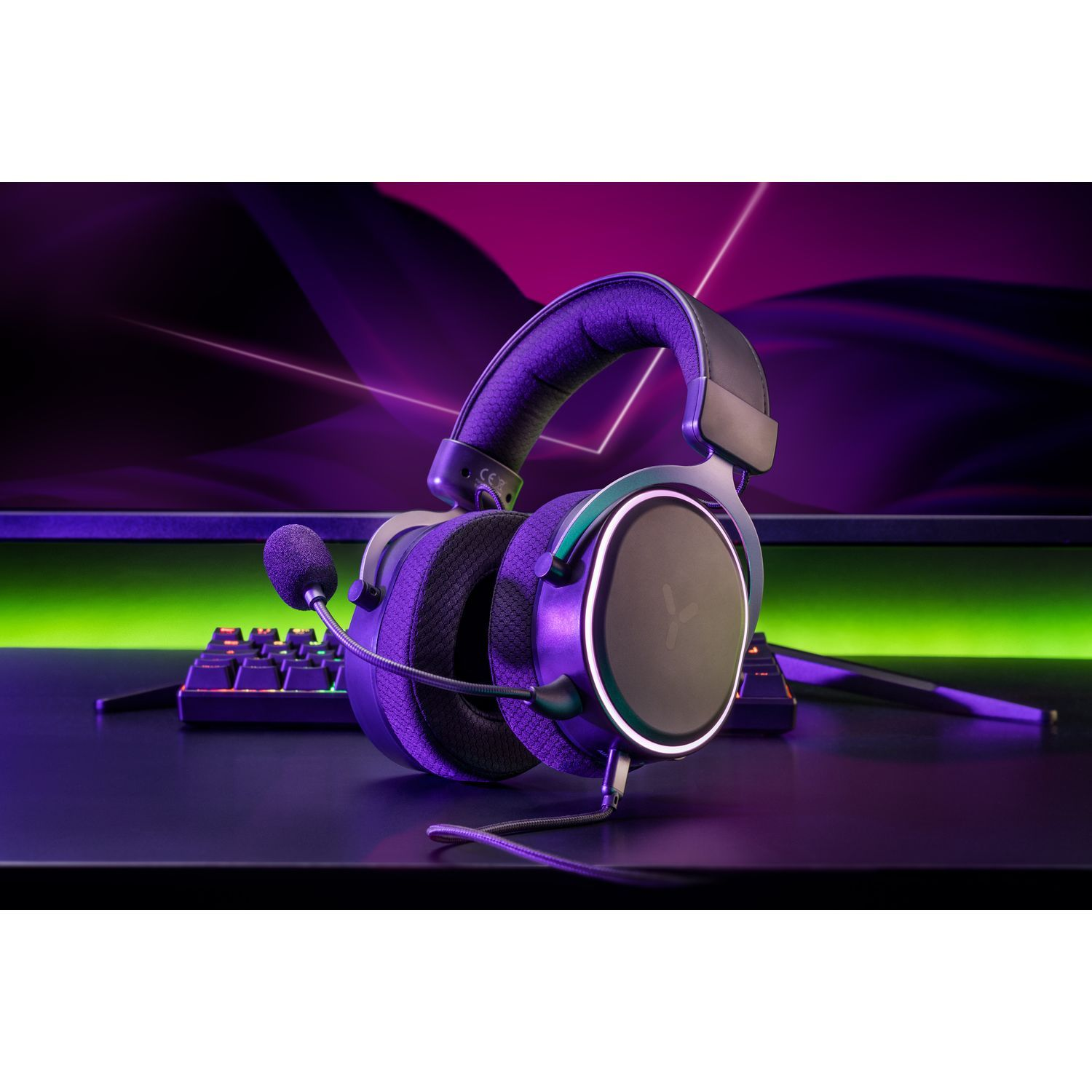 Headphones with a microphone, on a black surface, with a blurred background.