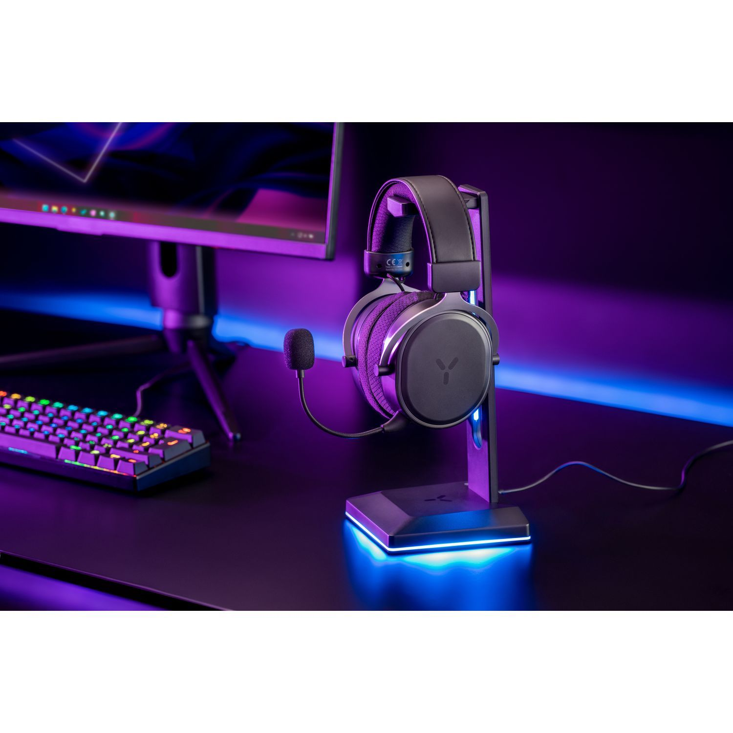 Headphones on a stand, keyboard and a monitor are visible.