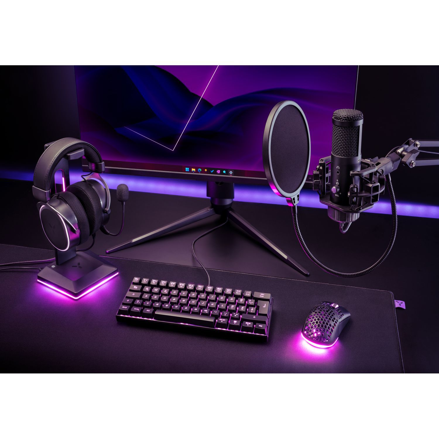 A gaming setup with headphones, microphone, keyboard, mouse, and monitor.