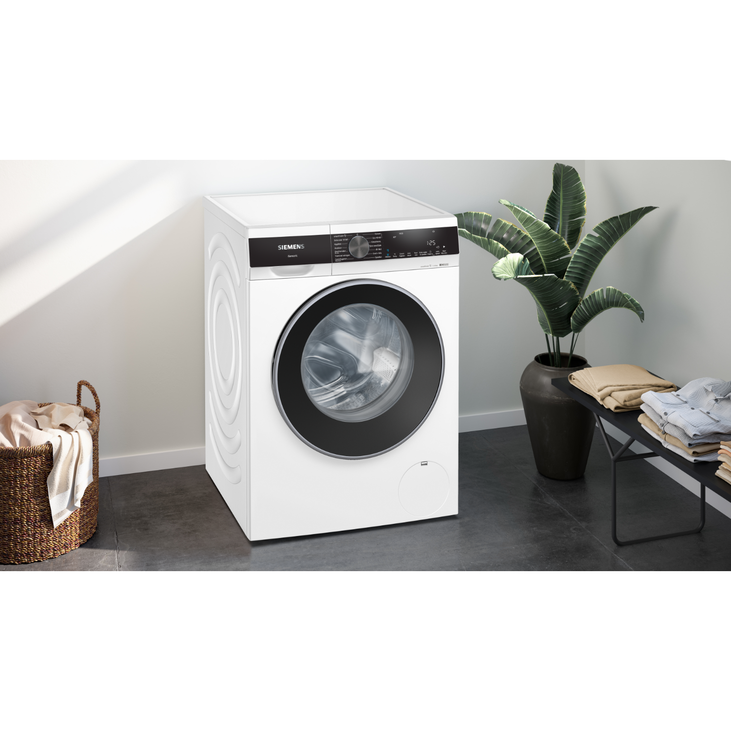 A white washing machine with a closed door in a room.