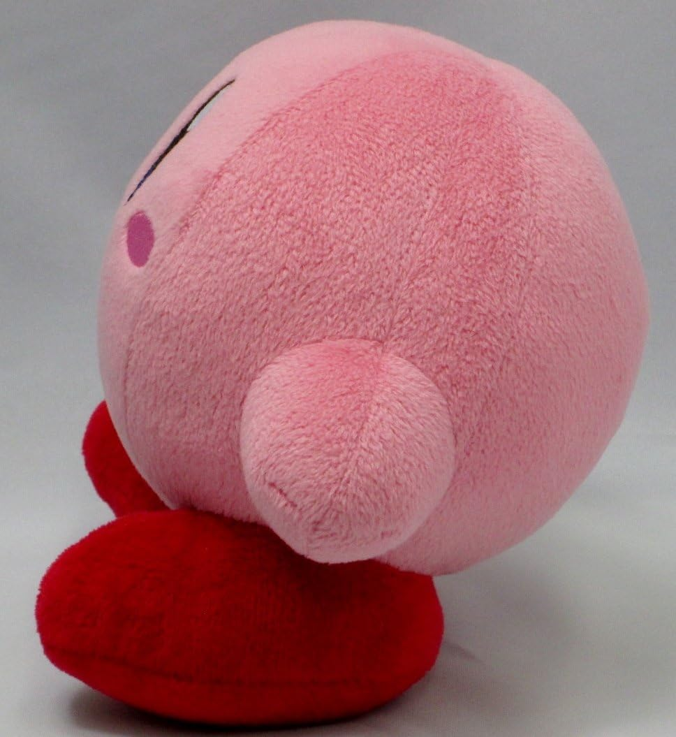 Ein pinkfarbenes Kirby-Plüschtier. Das Spielzeug ist größtenteils rosa, mit roten Füßen und rosa Rouge.
