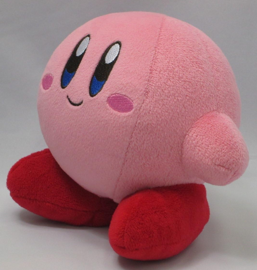 Rosa Kirby-Plüschtier. Runder Körper, große Augen, kleine Arme und rote Füße. Weißer Hintergrund.